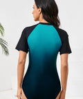 Back view of Women One Piece Rash Guard With Built In Bra Front Zip For Easy On Off No Fuss Convenience Short Sleeve Surfing Athletic Swimsuit UPF50 Full Lined Support Ombre Turquoise Black Size Large