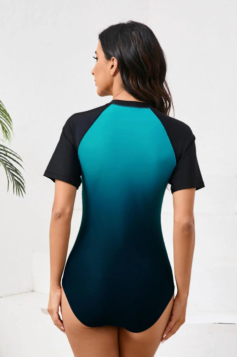 Back view of Women One Piece Rash Guard With Built In Bra Front Zip For Easy On Off No Fuss Convenience Short Sleeve Surfing Athletic Swimsuit UPF50 Full Lined Support Ombre Turquoise Black Size Large