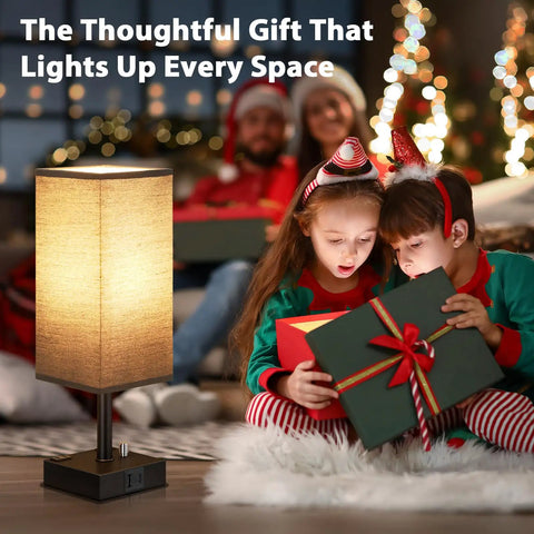 Black Fully Dimmable Nightstand Lamps Set Of 2 With USB C And USB A Ports next to children opening gifts in a living room.