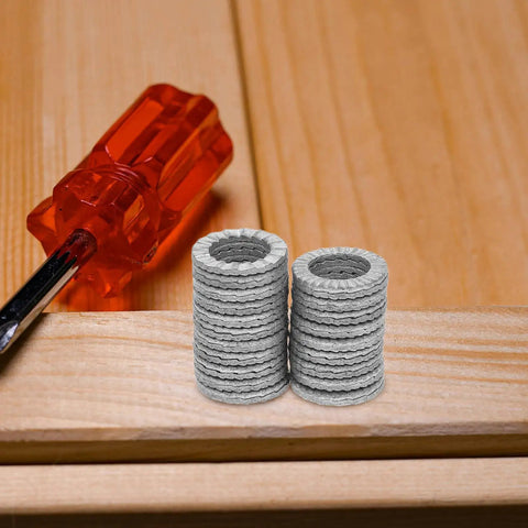 Set Of Twenty M10 Wedge Locking Washers Built Tough With Premium Manganese Steel stacked beside a red screwdriver on wood.