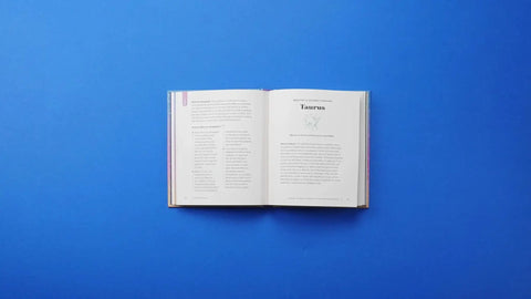 Open astrology book showing Taurus transit information, part of 'Handle The Mercury Retrograde Chaos Without Losing Your Cool With This Essential Astrology Guide To Level Up Your Chat Skills And Keep Your Daily Vibes Locked.'