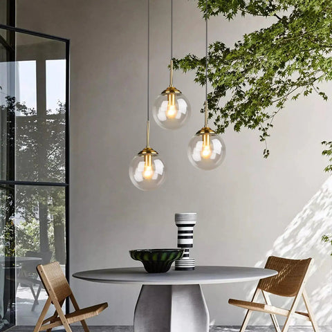 Three Light Pendant Light Fixtures With Brass Lamp Holder And Handblown Glass Shade, 5.9 Inch Globe Shade over dining table
