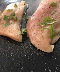 Raw chicken seasoned with herbs on Heavy Duty Grill Mats Set Of 5 Nonstick BBQ Mats For Outdoor Grilling And Indoor Baking Reusable