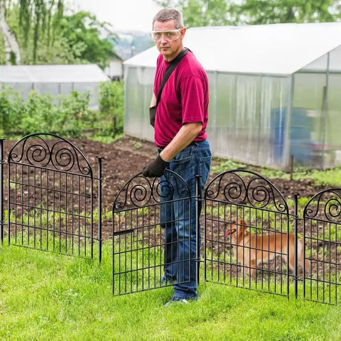 Man installing Tall Dog Fence With Gate, 40 Inch High Garden Boundary Fences, 12 Panels Spanning 26.2 Feet, Metal Temporary Yard Enclosure For Pets.