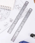 6 Inch Stainless Steel Ruler Set Of 4 With Safe Non Sharp Edge For Students And DIY Projects Durable Rustproof Metal Measuring Tool For Precise Lines And Crafting placed on technical drawings.