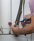 Man installing Foam Pipe Insulation Sticks For Hot And Cold Water Lines Pre Slit With Self Sealing Edge 0.75 Inch