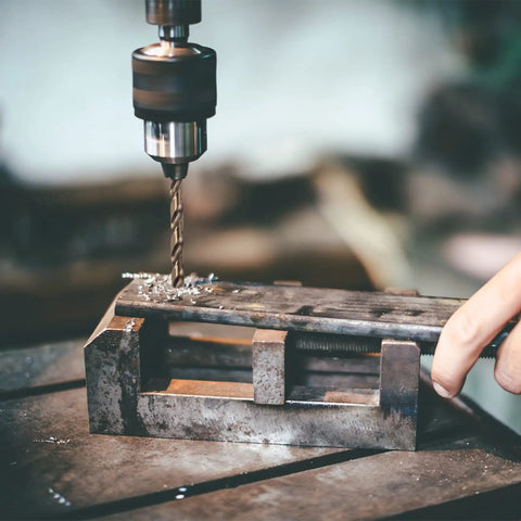Close-up of drill press using a 29-Piece M35 Cobalt Drill Bit Set For Steel And Hardened Metals, 1/16 To 1/2 Inch Bits