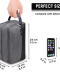 Lightweight Denim Grey Hanging Dopp Kit For Men Travel Toiletry Bag next to iPhone X for size comparison, hand holding handle