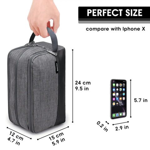 Lightweight Denim Grey Hanging Dopp Kit For Men Travel Toiletry Bag next to iPhone X for size comparison, hand holding handle