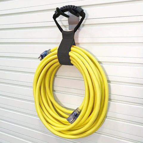 Versatile 17 Inch Adjustable Black Nylon Storage Strap With Ergonomic Handle For Cords Garden Hoses Swimming Gear And Garage Tools Heavy Duty Organizer With Strong Velcro For Reusable Easy Grab And Go Neat Storage holding a yellow garden hose on a white wall.