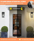 Outdoor Wall Lanterns With Dusk To Dawn Sensor illuminating porch at night, sleek black aluminum design with crack-like glass, IP65 waterproof.