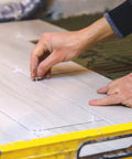 White 1/16-inch cross tile spacers, 500-pack, shown on ceramic tiles during installation