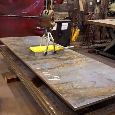 Heavy Duty Switchable Lifting Magnet With 12000 Pounds Breakaway Force lifting a steel plate in a workshop setting.