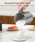 Hand pouring milk foam into cup using 4 In 1 Electric Milk Frother And Steamer, 16.9 Oz Capacity, on kitchen counter.