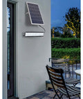 JUDYSSY Solar Powered Street Flood Lights Outdoor Led Waterproof Lamp with Remote Control mounted on a wall with solar panel.