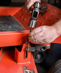 Using Nine Piece Roll Pin Punch Set Pro Grade With Durable Heat Treated Drop Forged Steel Pins on red automotive frame