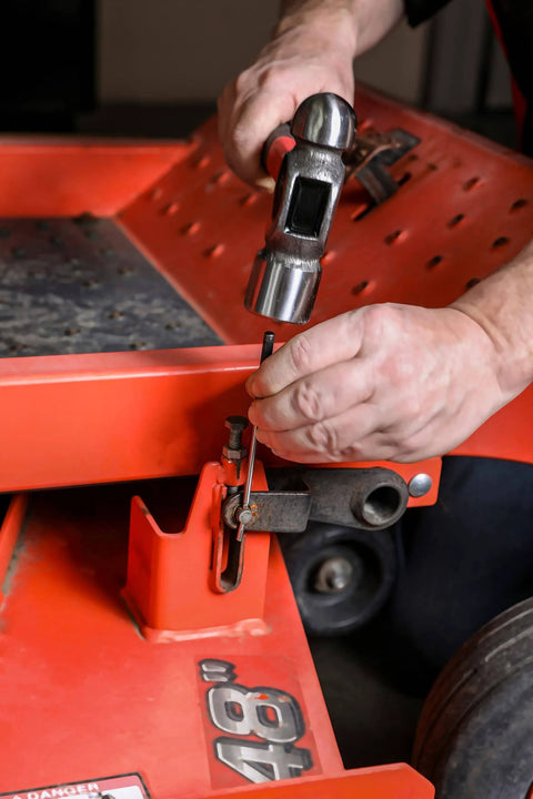 Using Nine Piece Roll Pin Punch Set Pro Grade With Durable Heat Treated Drop Forged Steel Pins on red automotive frame