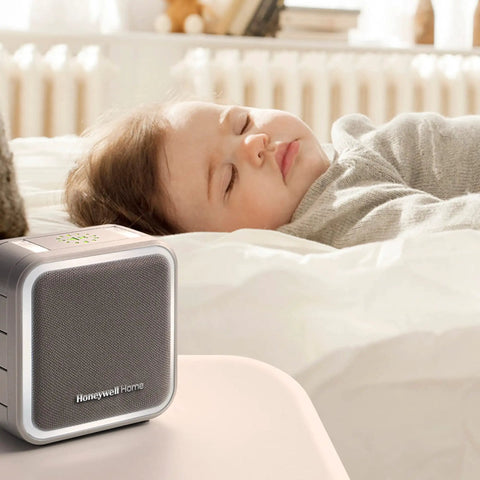 Portable Wireless Doorbell With Push Button, 350 Ft Range, 6 Tunes, 7 LED Halo Colors, gray finish on bedside table