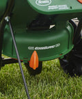 Edge Guard Mini Broadcast Spreader With Calibrated Settings And Wheels on grass, ideal for lawns up to 5,000 sq ft.