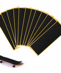 24 Pack Foam Grip Tape for Fingerboards 38x110mm Anti Slip PU Foam Self Adhering Black Grippy Tape displayed with mini skateboard