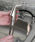 Brushed Nickel Kitchen Sink Side Spray Head 1 Pack With Easy On Off Thumb Control, shown being installed on faucet