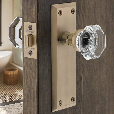 Crystal Door Knob With Back Plate In New York And Waldorf Style on wooden door, vintage glass knob and brass plate.