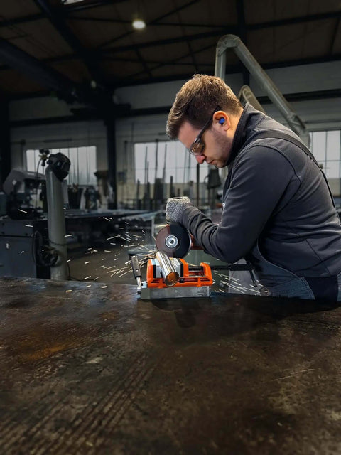 Heavy Duty Cordless Angle Grinder 115mm With Slick Brushless Motor And 18V Power For Smooth Sanding Deburring And Precision Jobsite Cutting in use with sparks flying.