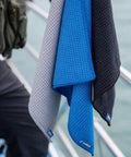 Grab And Go Clip On Microfiber Fishing Towels With Waffle Pattern, Quick Dry 16x16 Inch Towels hanging on railing, blue grey black