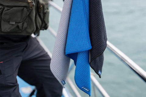 Grab And Go Clip On Microfiber Fishing Towels With Waffle Pattern, Quick Dry 16x16 Inch Towels hanging on railing, blue grey black