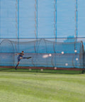 Soccer player using Power Alley 22 Ft Durable Home Soccer Cage For Backyard Practice And Skill Building outdoors