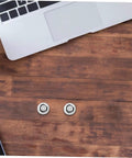 Two Ten Pack Hella Secure Self Tapping PC Case Screws on a wooden table with a laptop nearby.