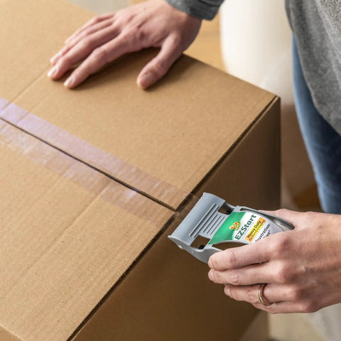 Hands using EZ Start Packing Tape With One Handed Dispenser 1.88 Inch By 55.5 Yard Crystal Clear Tape Roll sealing a box