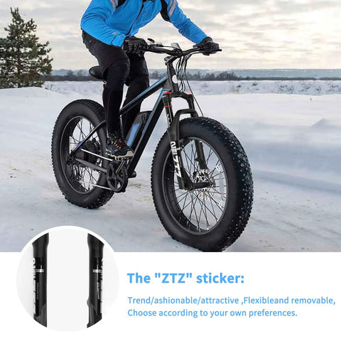 Cyclist on snow with bike featuring Front Fork For Four Inch Fat Tires With 130mm Travel And Crown Lockout, 135mm Hub, 9mm QR