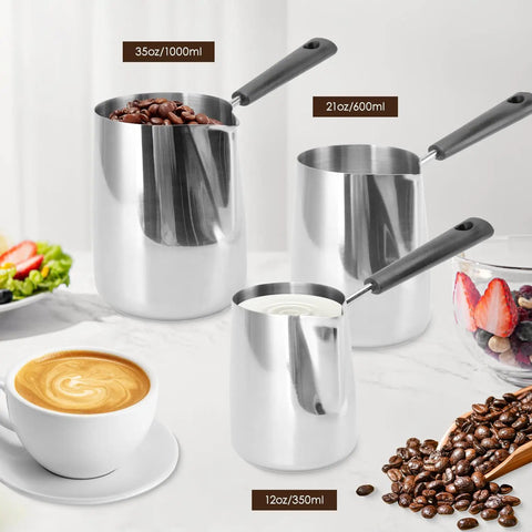 Turkish Coffee Pot And Milk Frothing Jug 21oz 600ml Stainless Steel Toroid Pitcher With Long Handle next to coffee beans and latte.