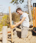 Man using a Heavy Duty Post Hole Digger With Fiberglass Handle 58 Inch Sharp Steel Blade For Quick Digging Through Hard Soil And Roots