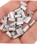 Kick Ass Heavy Duty Aluminum Cable Sleeves, Eight Shaped Snare Wire Ferrules for USB C Charger Ends, hand holding silver ferrules.