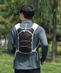 Person wearing Hydration Backpack For Hiking And Trekking, Outdoor Waterproof Gear, Unisex Hydration Pack with adjustable straps.
