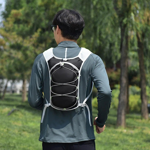 Person wearing Hydration Backpack For Hiking And Trekking, Outdoor Waterproof Gear, Unisex Hydration Pack with adjustable straps.