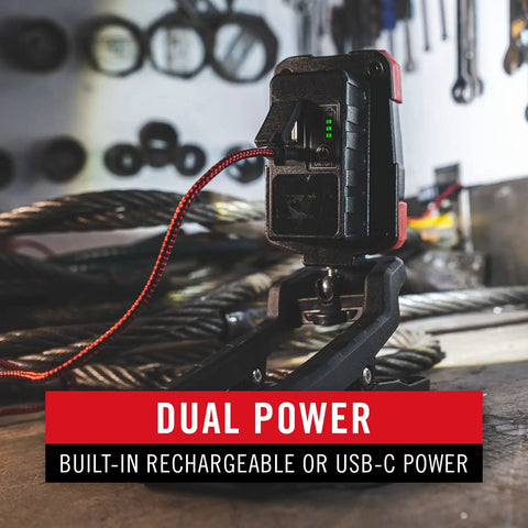 Rechargeable Dual Power LED Work Light with Magnetic Clamp in use on construction site, showing USB-C charging in black red finish.
