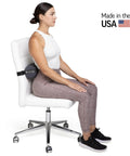 The Original McKenzie Lumbar Roll Standard Density Low Back Support Pillow for Comfort spinal alignment used on office chair by woman.