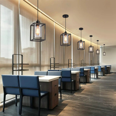 Rock Solid Black Pendant Lights For Kitchen Island, 3 Pack Sleek Industrial Farmhouse Lanterns with adjustable height above blue seating area.
