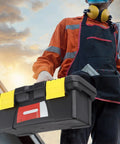 10 Inch Plastic Toolbox With Dual Layer Organization And Secure Latch held by worker in orange gear