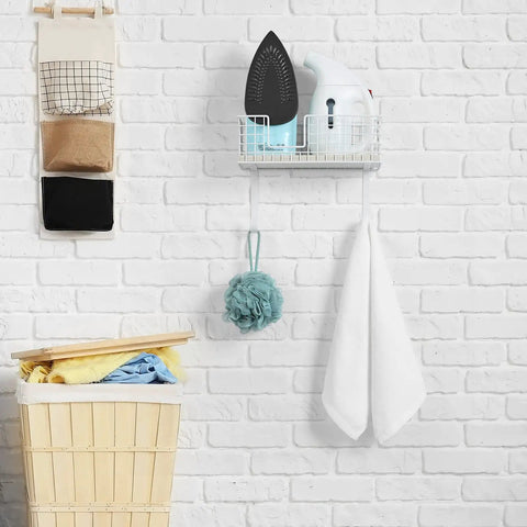 Wall Mounted Ironing Board Holder With Storage Shelf And Removable Hooks No Fuss Install Heavy Duty Laundry Room Iron Organizer for Iron and Board Large Basket White Finish Keeps Your Laundry Space Neat And Ready visible on brick wall.