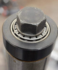 Close-up of Astro Pneumatic Tool 78835 exhaust pipe stretcher kit component; metallic with black cylindrical housing and hex bolt.