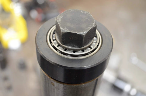 Close-up of Astro Pneumatic Tool 78835 exhaust pipe stretcher kit component; metallic with black cylindrical housing and hex bolt.