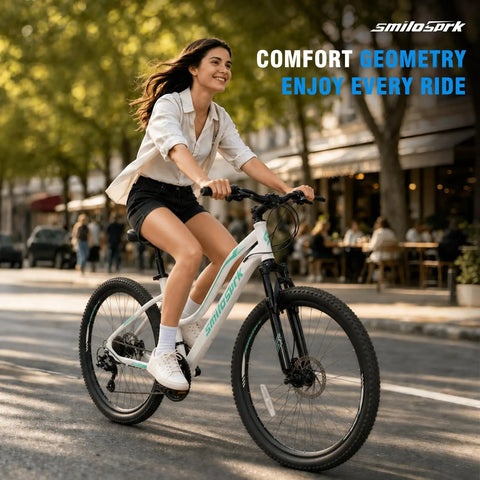 Woman riding Women’s 26 Inch Mountain Bike For Adults With Shimano Rear Derailleur And Twist Grip Shifter 21 Speed Shifting Dual Disc Brakes Lockout Suspension in city