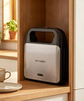 Keinve 3 In 1 Sandwich Maker And Waffle Iron With Removable Non Stick Plates resting in a kitchen nook with a cool touch handle.