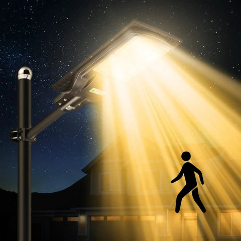 Ultra Bright Solar Street Lights Outdoor 180 LED Chips with Motion Sensor illuminating a yard at night.
