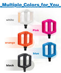Kid Friendly 1/2 Inch Thread Universal Lightweight Non Slip Nylon Flat Pedals for Kids Bikes in multiple colors, black, blue, pink, orange, and white.