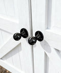 Close-up of Built Tough Heavy Duty Matte Black Barn Door Pull Handle Solid Zinc Alloy Ring Knob on wooden double doors.